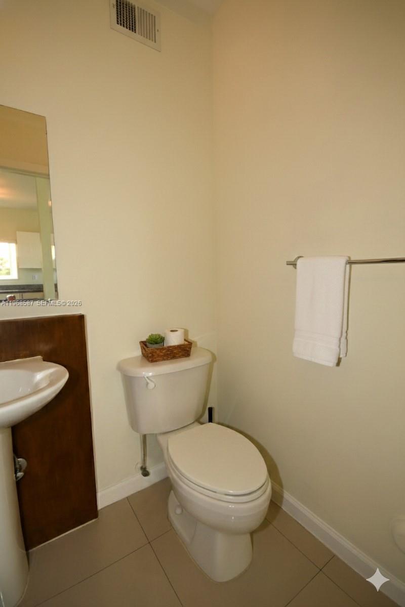 2780 Southwest 33rd Avenue Miami, FL 33133 - Photo 25 of 52 a white toilet sitting next to a bathroom sink