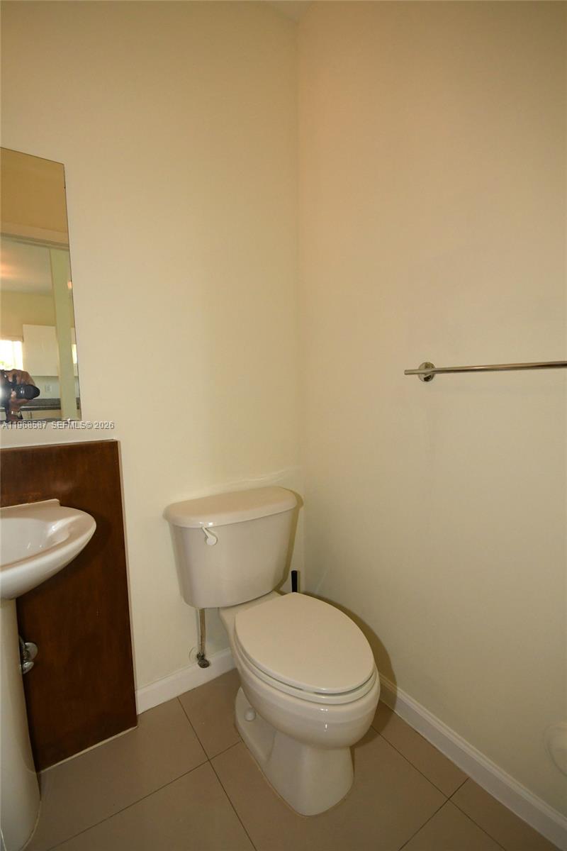 2780 Southwest 33rd Avenue Miami, FL 33133 - Photo 26 of 52 a white toilet sitting next to a bathroom sink
