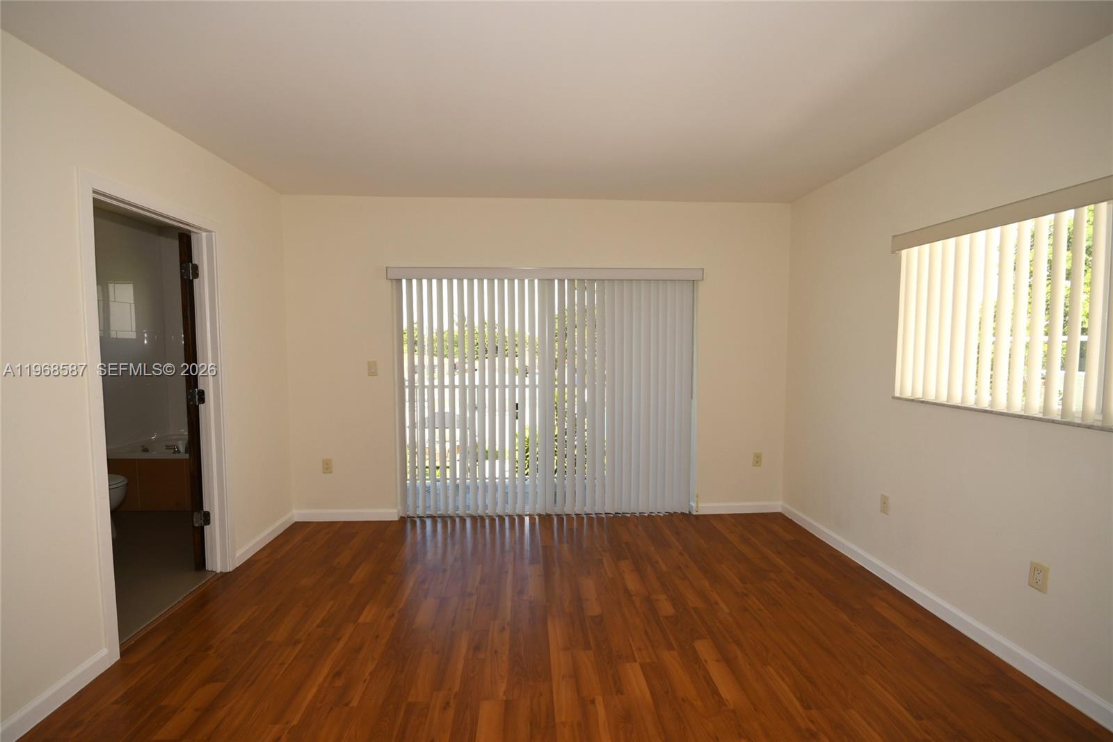 2780 Southwest 33rd Avenue Miami, FL 33133 - Photo 39 of 52 an empty room with wooden floor and windows