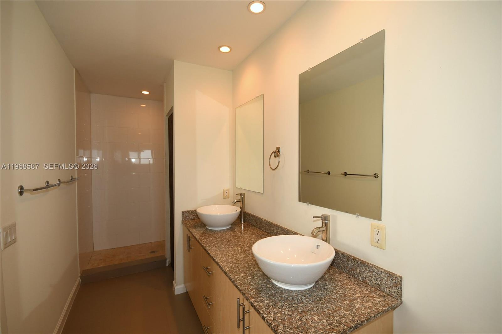 2780 Southwest 33rd Avenue Miami, FL 33133 - Photo 41 of 52 a bathroom with a granite countertop sink and a mirror