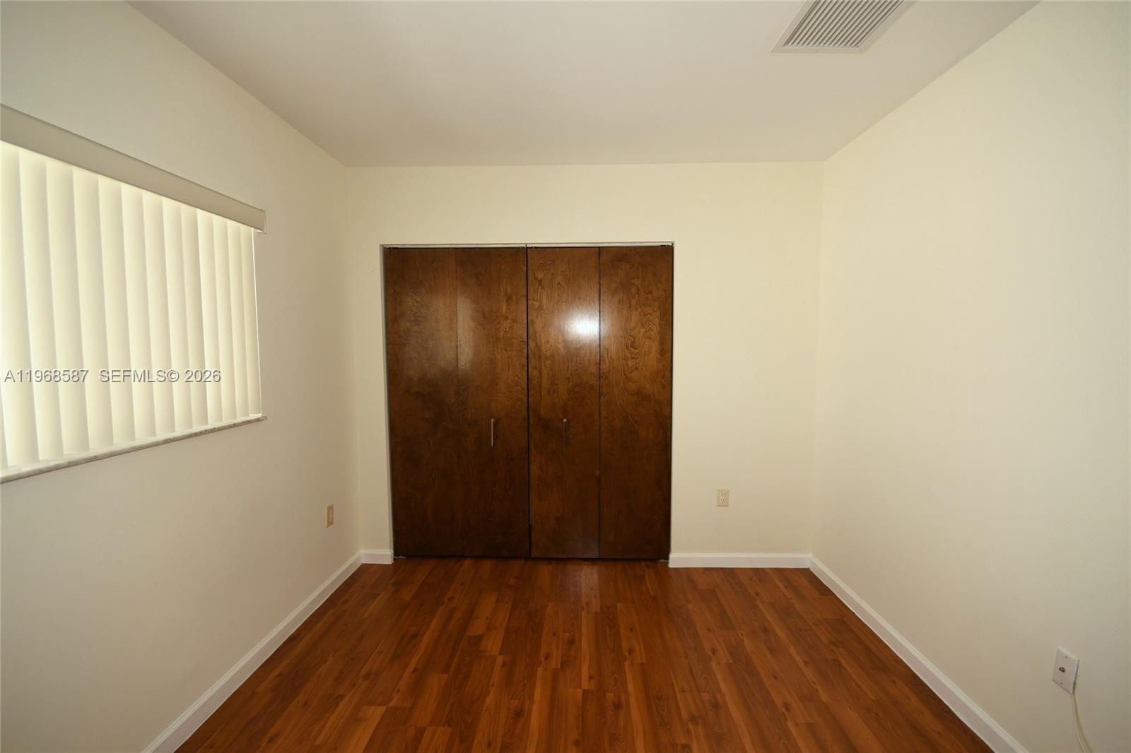 2780 Southwest 33rd Avenue Miami, FL 33133 - Photo 46 of 52 a view of an empty room with wooden floor and a window