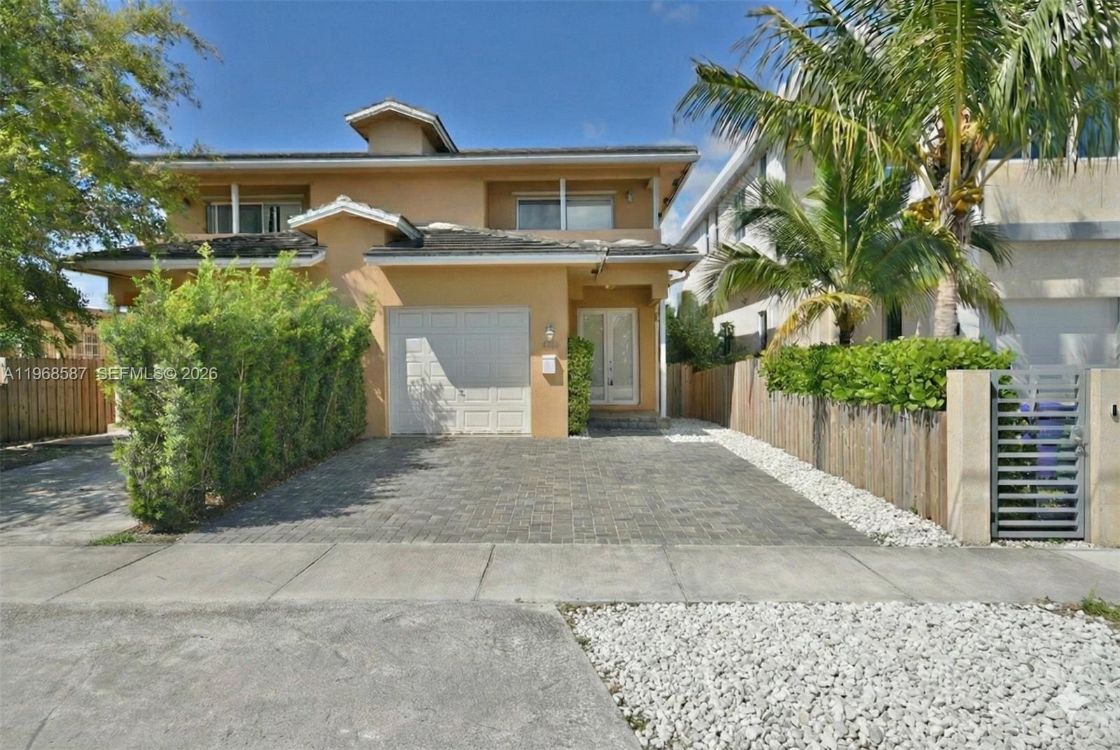 2780 Southwest 33rd Avenue Miami, FL 33133 - Photo 50 of 52 a front view of a house with a yard and garage