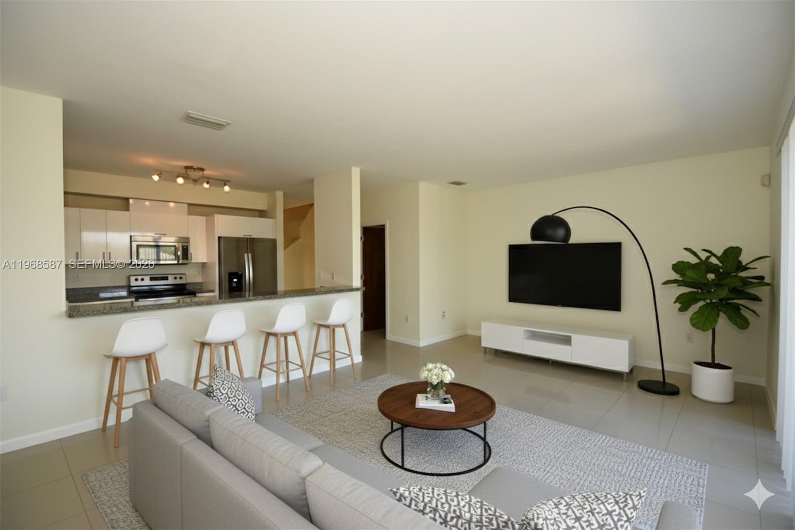 2780 Southwest 33rd Avenue Miami, FL 33133 - Photo 7 of 52 a living room with furniture and a flat screen tv