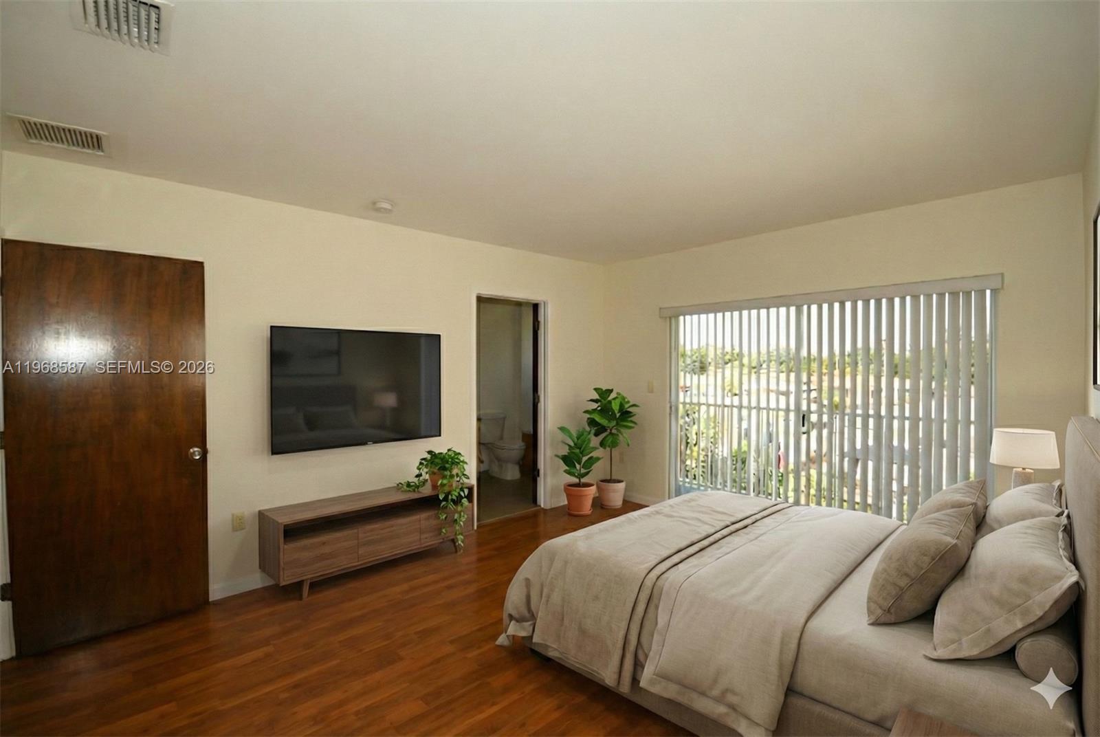 2780 Southwest 33rd Avenue Miami, FL 33133 - Photo 9 of 52 a bedroom with a bed and a flat screen tv