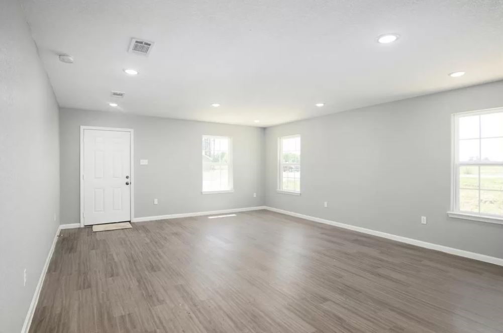 23338 Sandpiper Trail Spring, TX 77373 - Photo 3 of 11 an empty room with wooden floor and windows