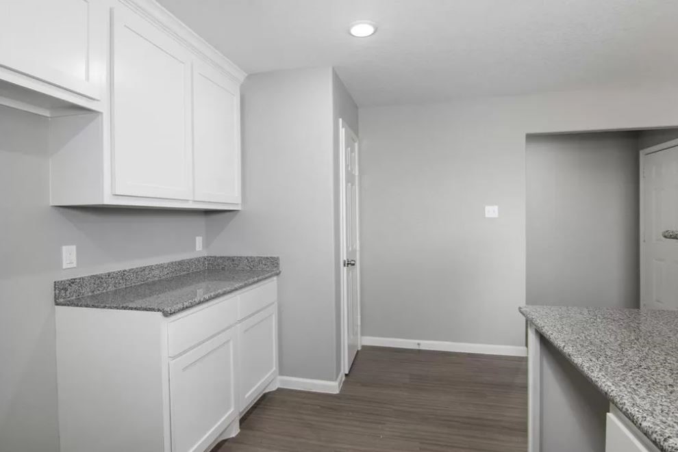 23338 Sandpiper Trail Spring, TX 77373 - Photo 6 of 11 a kitchen with granite countertop white cabinets and a granite counter tops