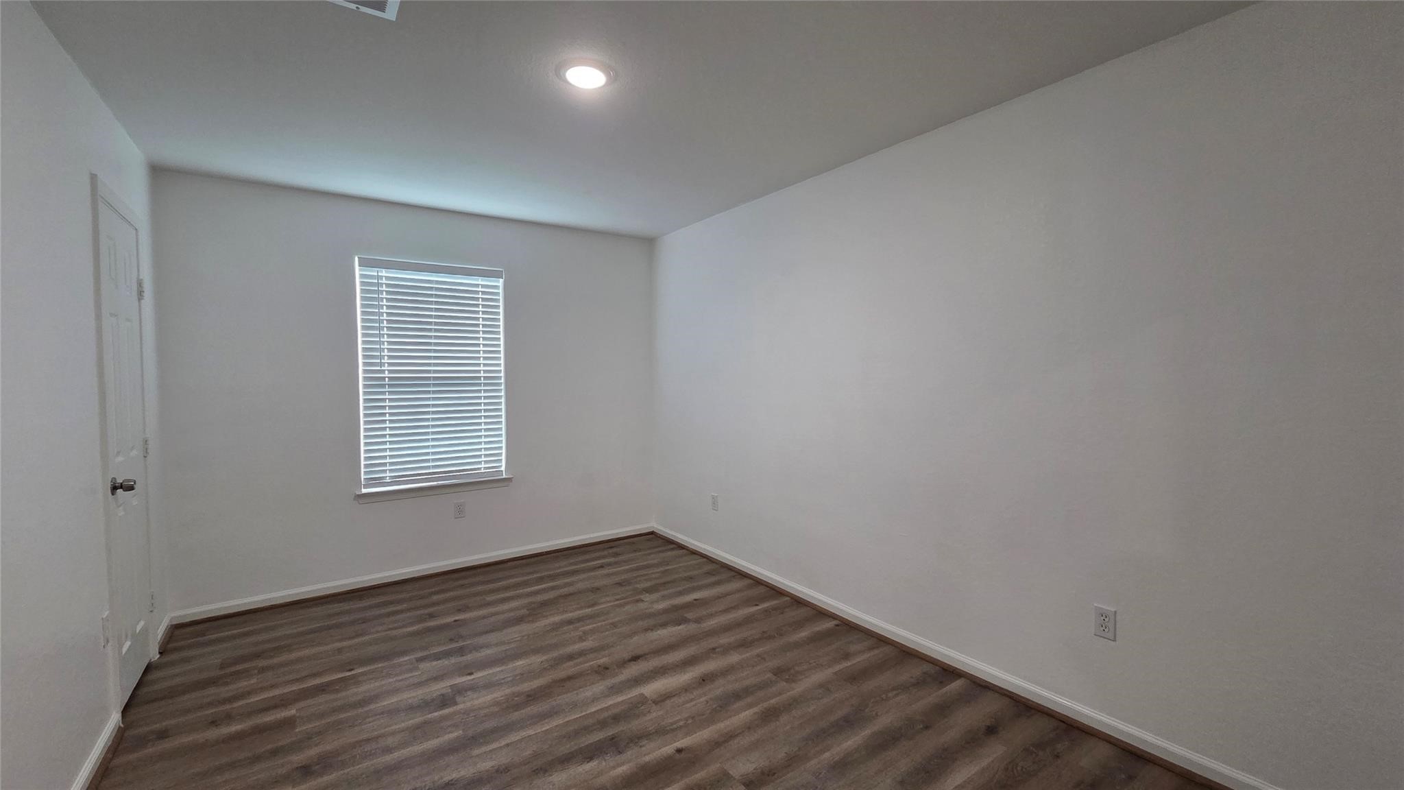 23338 Sandpiper Trail Spring, TX 77373 - Photo 10 of 11 a view of an empty room with wooden floor and a window