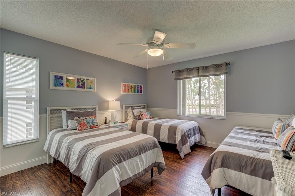 760 Augusta Boulevard, Unit D204 Naples, FL 34113 - Photo 12 of 20 a bedroom with two beds and a window