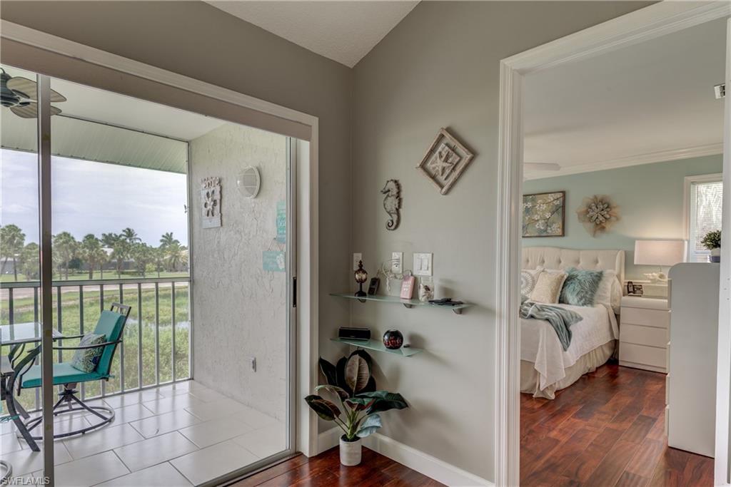 760 Augusta Boulevard, Unit D204 Naples, FL 34113 - Photo 18 of 20 a bedroom with furniture and a window