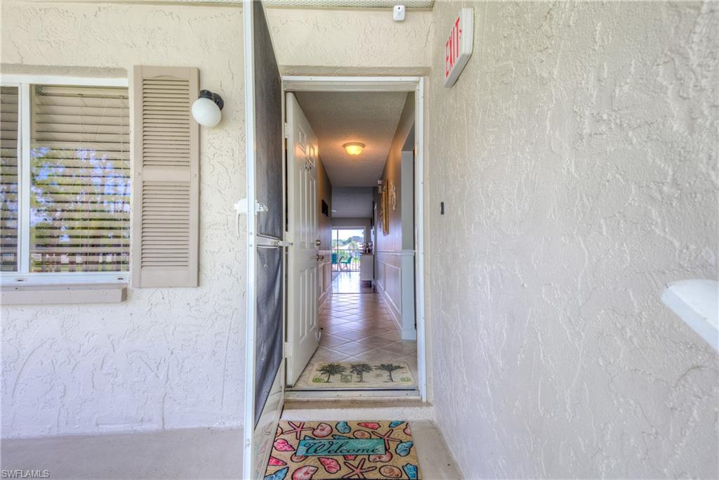 760 Augusta Boulevard, Unit D204 Naples, FL 34113 - Photo 3 of 20 a view of a hallway with wooden floor and a bathroom