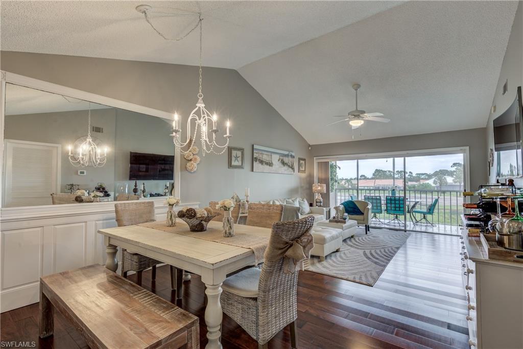 760 Augusta Boulevard, Unit D204 Naples, FL 34113 - Photo 6 of 20 a view of a dining room with furniture large windows and wooden floor