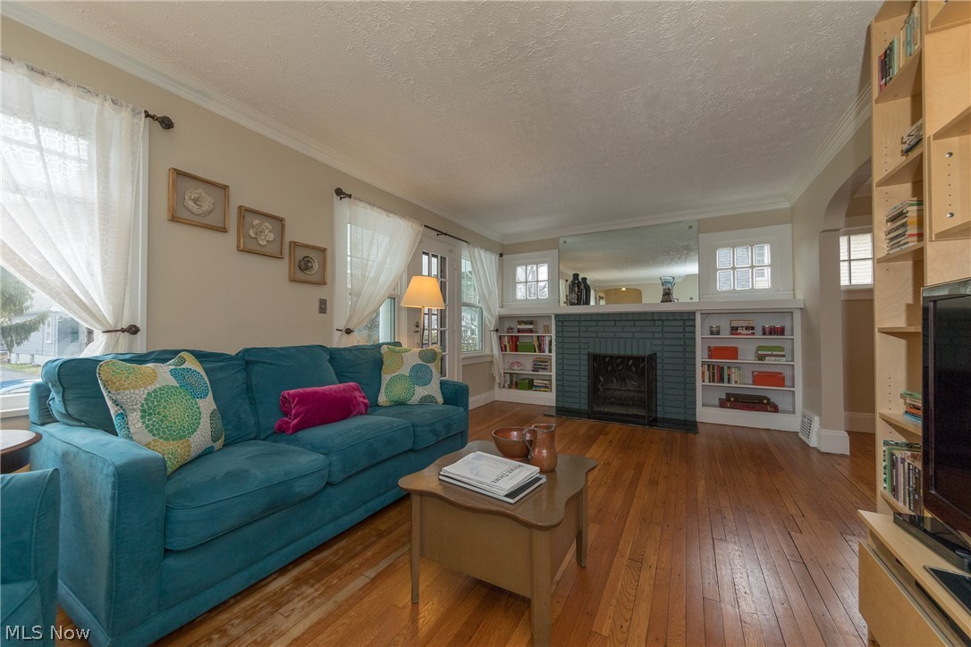 3996 Rosemond Road Cleveland Heights, OH 44121 - Photo 2 of 29 The Living Room, with wonderful, rich hardwood floors and the brick fireplace, with its accompanying bookcases, as the focal point