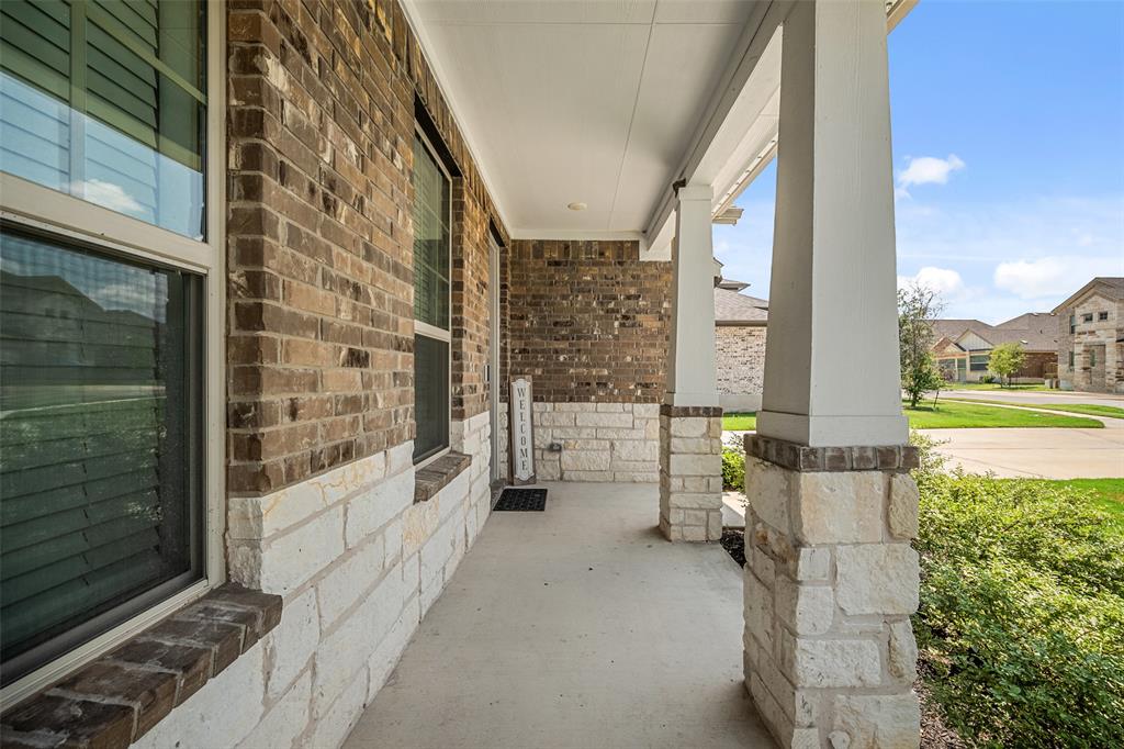265 Fawn Riv Run Kyle, TX 78640 - Photo 2 of 39 Stone and brick pillars support a welcoming covered entry porch.