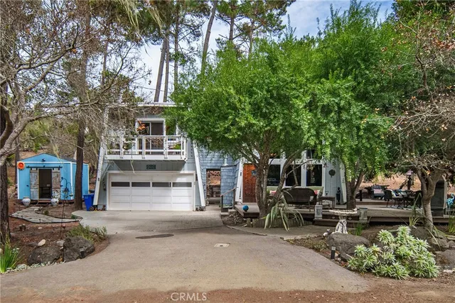 a row of table and chairs in front of house