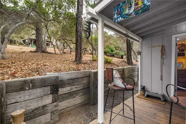 a view of a porch with furniture and wooden floor