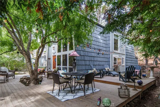 a view of backyard with outdoor seating and trees