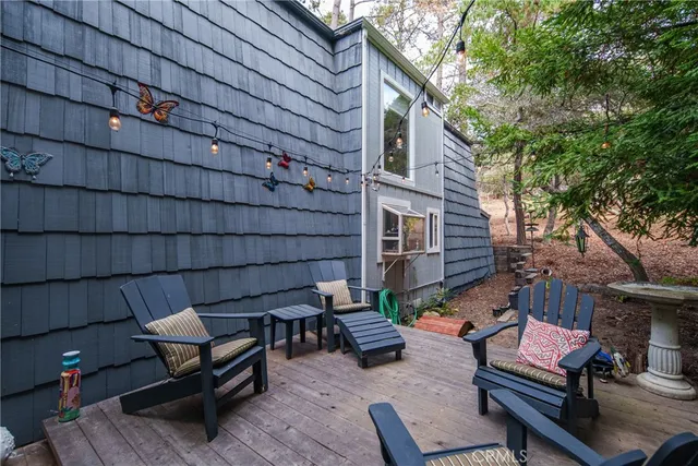 a backyard of a house with barbeque oven and outdoor seating