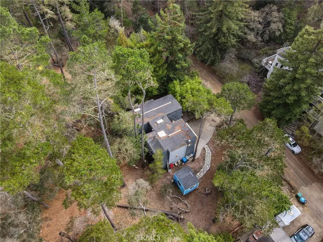 an aerial view of a house with a yard