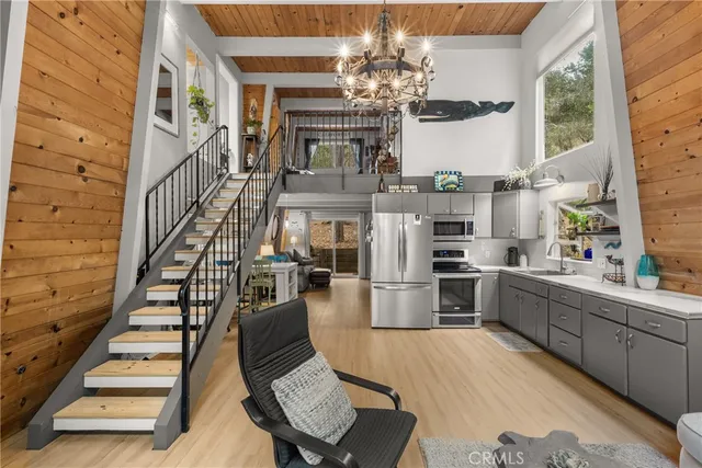 a view of a dining room with furniture a chandelier and wooden floor