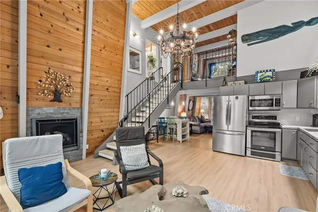 a living room with furniture a fireplace and kitchen view
