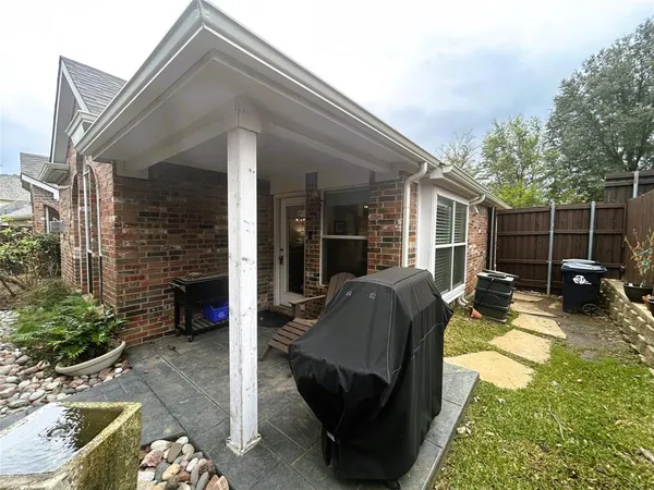 a view of a patio with table and chairs a barbeque with wooden fence