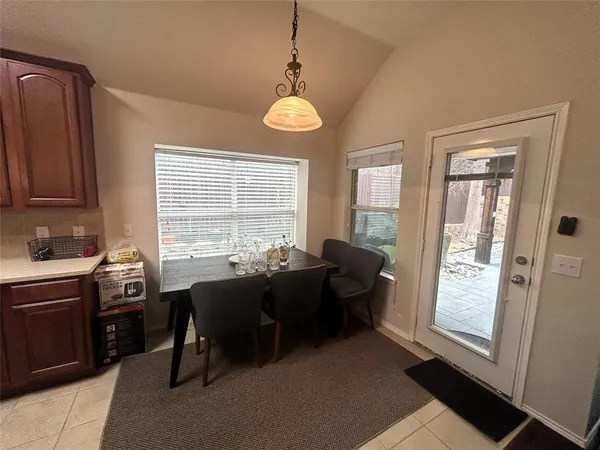 a view of a dining room with furniture and windows