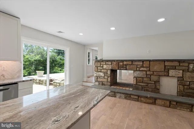 a living room with furniture a flat screen tv and a floor to ceiling window