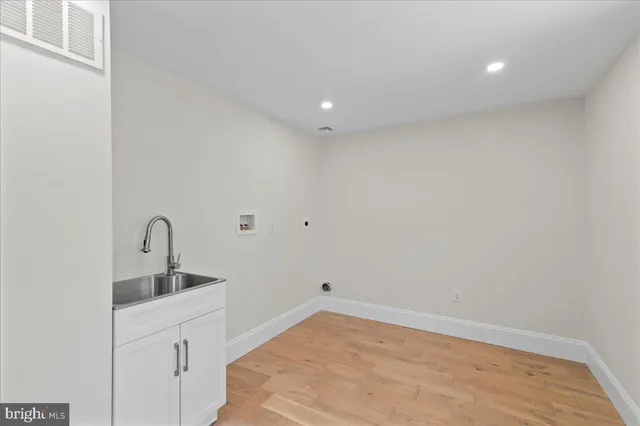 a kitchen with sink and cabinets