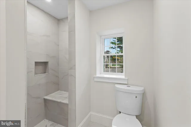a white toilet sitting next to a bathroom sink