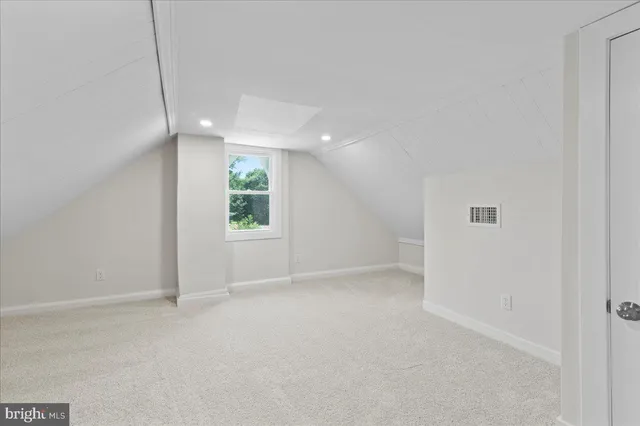 a view of an empty room with windows