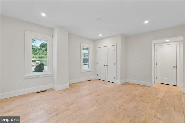 an empty room with windows and closet