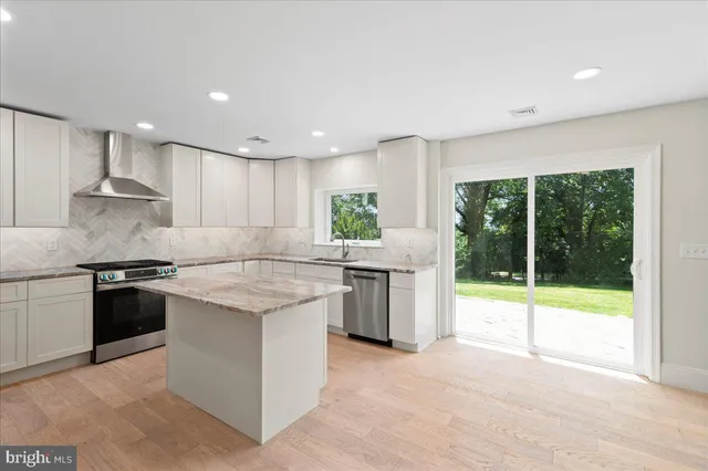 a kitchen with a stove a sink and a refrigerator