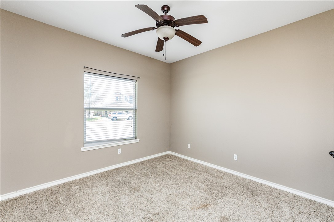 8221 Azimuth Court Corpus Christi, TX 78414 - Photo 27 of 40 an empty room with a window and a ceiling fan