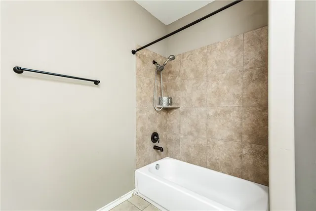 a bathroom with a granite countertop toilet sink and mirror