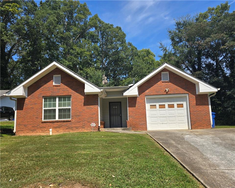 3725 Collier Drive Northwest Atlanta, GA 30331 - Photo 14 of 31 a front view of a house with a yard and garage