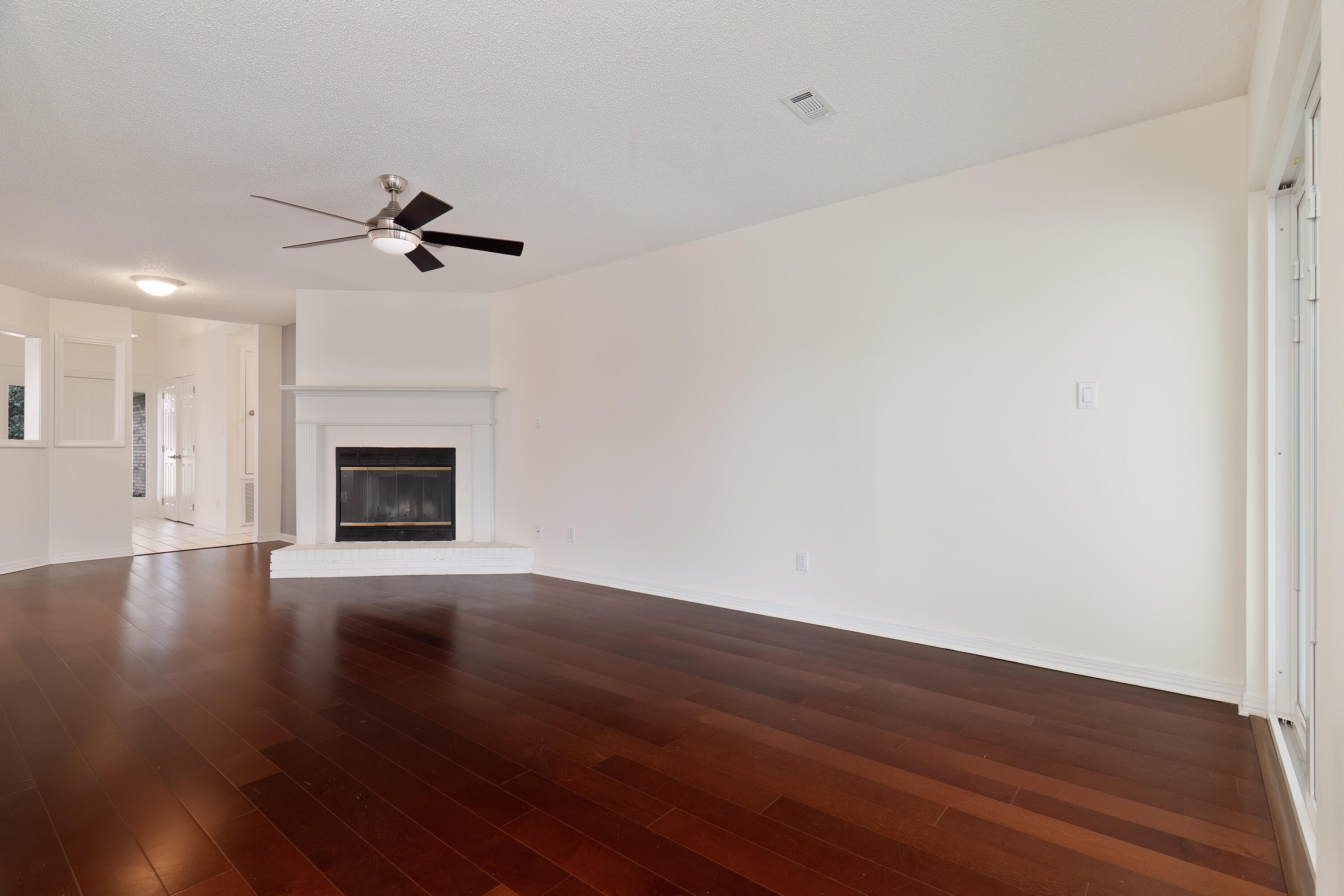 946 Shalimar Point Drive Shalimar, FL 32579 - Photo 18 of 63 a view of empty room with wooden floor and fireplace