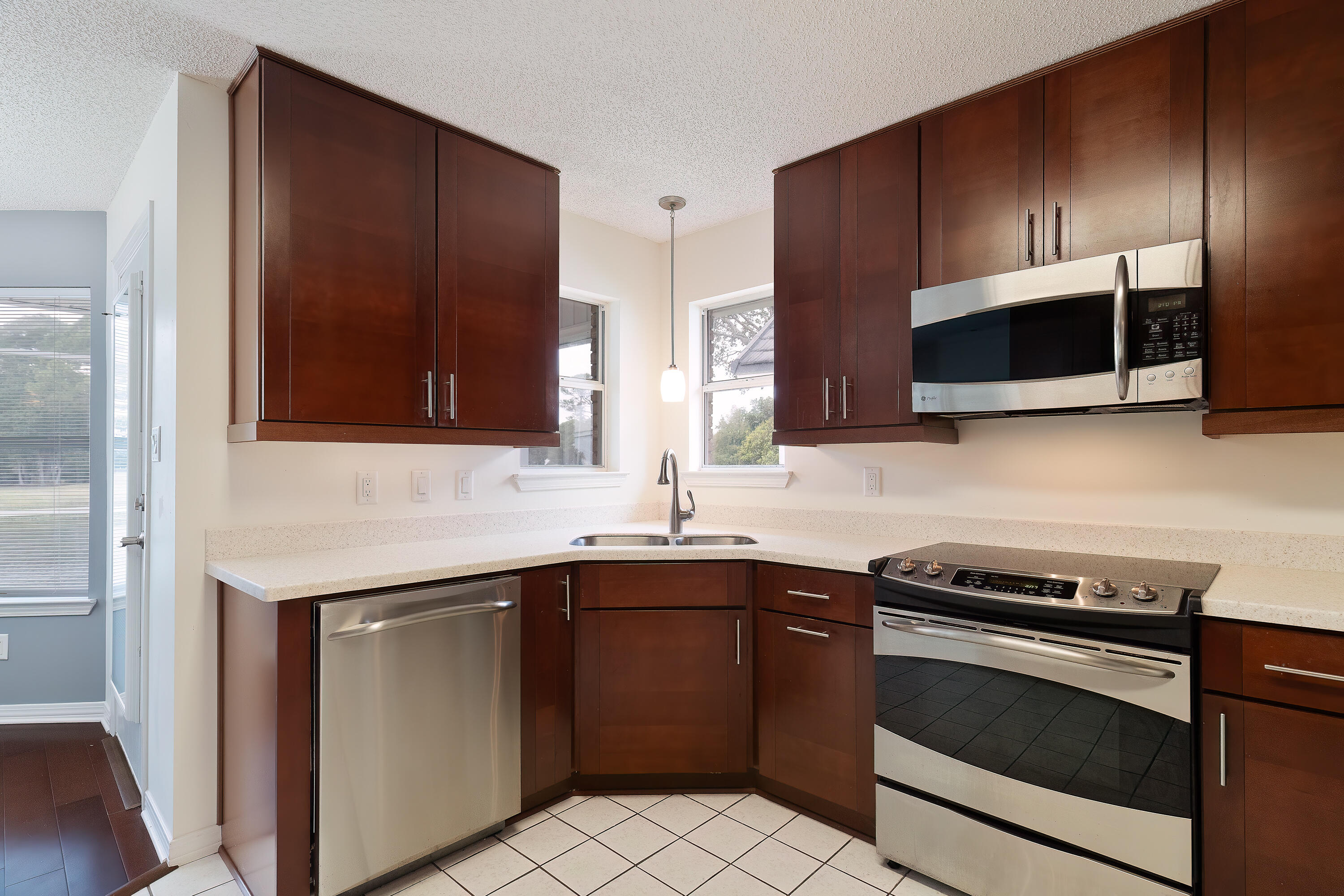 946 Shalimar Point Drive Shalimar, FL 32579 - Photo 19 of 63 a kitchen with stainless steel appliances a sink stove and microwave