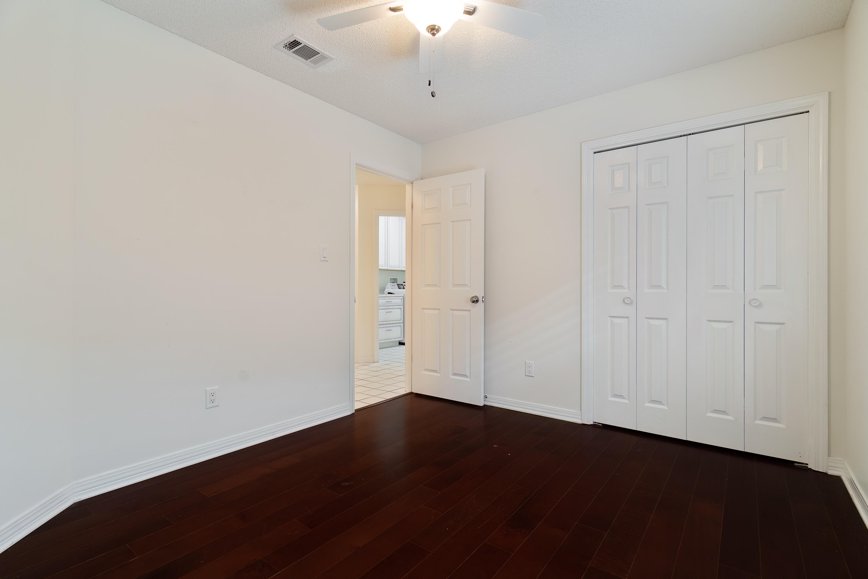946 Shalimar Point Drive Shalimar, FL 32579 - Photo 39 of 63 an empty room with a ceiling fan and wooden floor