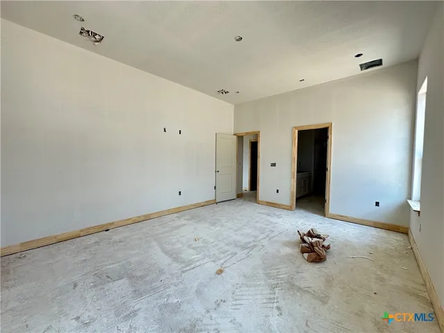a view of a room with gym equipment and a window