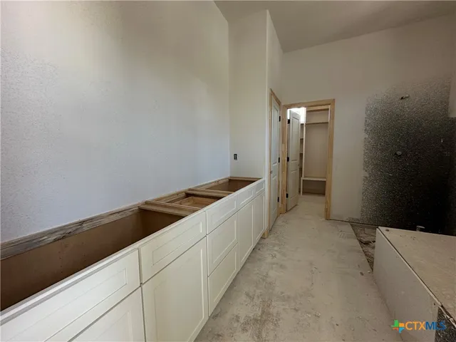 a large white kitchen with white cabinets