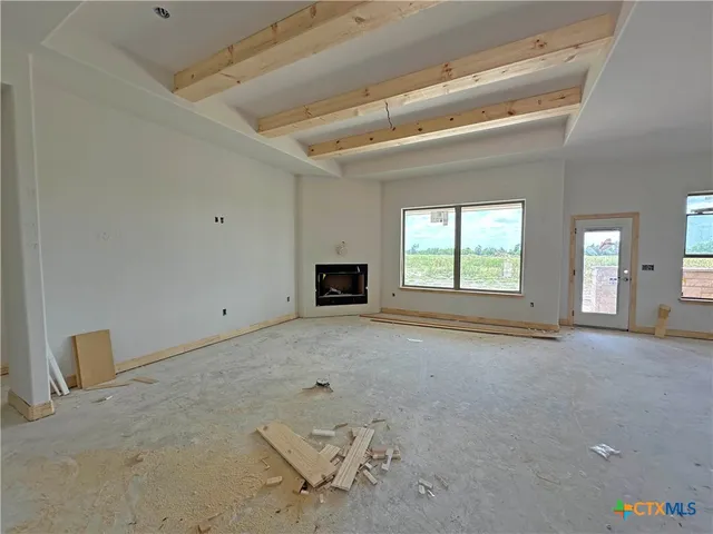 a view of a livingroom with a fireplace and window