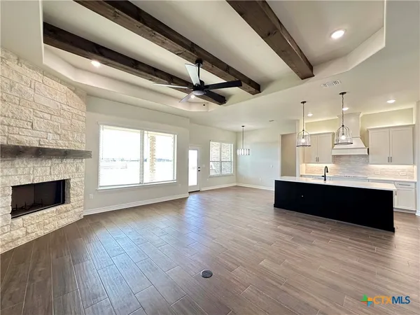a living room with hard wood floors and a fireplace