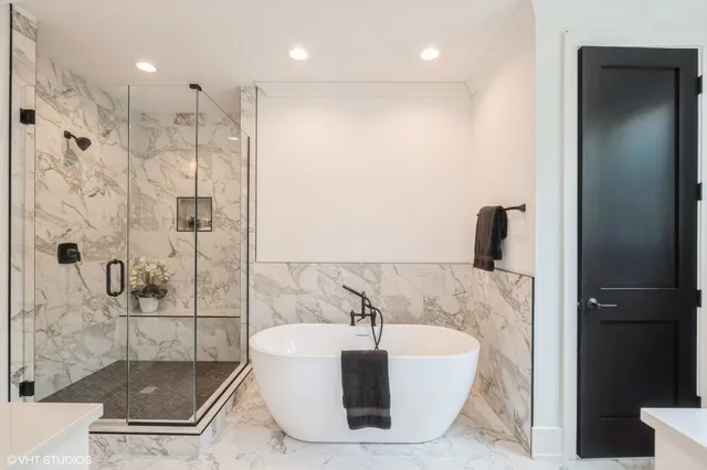 a bathroom with a bathtub and a shower