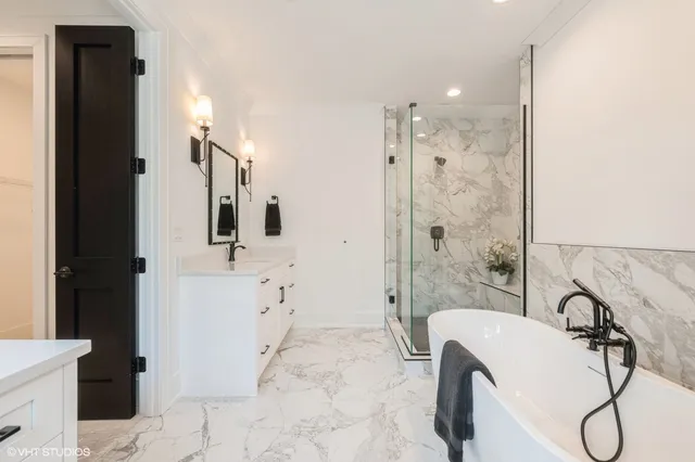 a bathroom with a granite countertop sink a toilet and shower