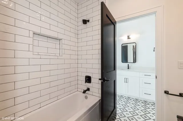 a bathroom with a bathtub and shower