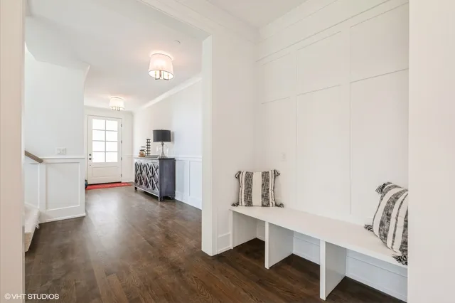 a view of a kitchen with furniture and wooden floor