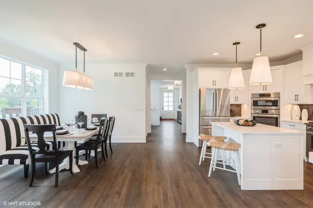 a dining room with furniture and wooden floor