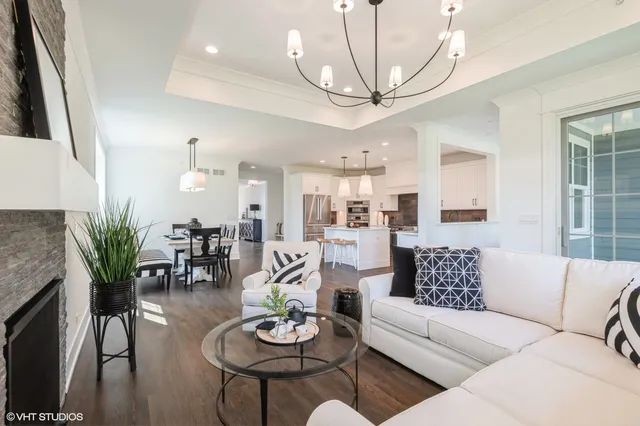 a living room with furniture potted plant and a flat screen tv