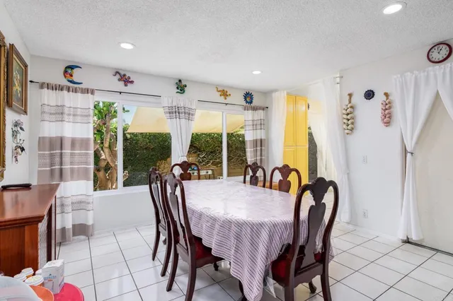 a kitchen with a refrigerator a stove top oven and a potted plant