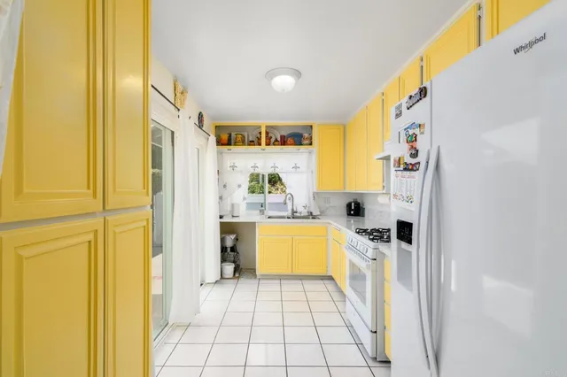 a kitchen with stainless steel appliances granite countertop a refrigerator and a stove